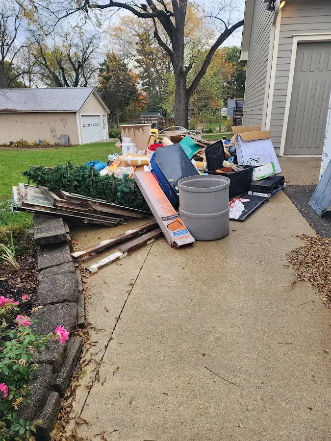 Dumpster being loaded with debris for Estate Cleanout Dumpster Rental in St. Michael